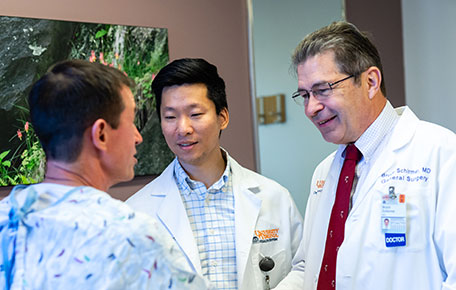 UVA Surgery faculty with Med student caring for a patient.
