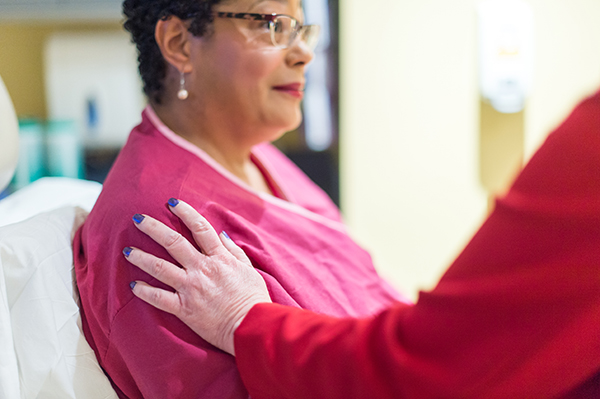 UVA Breast and Melanoma Surgery Division care provider comforts a patient