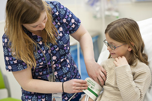 UVA nurse taking the blood pressure of a pediatric patient