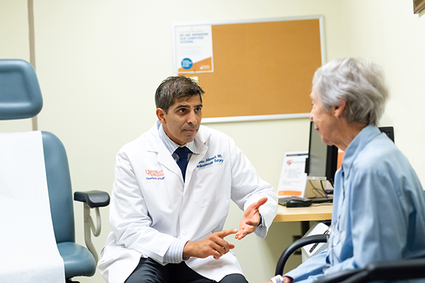 UVA Cardiac surgeon consulting with a patient before surgery.