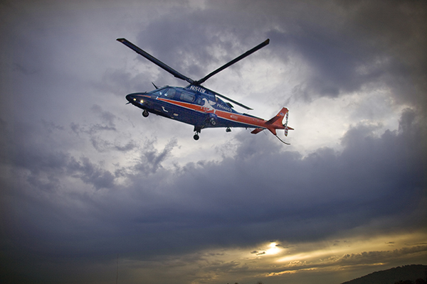 UVA Pegasus helicopter hovering against a sunset