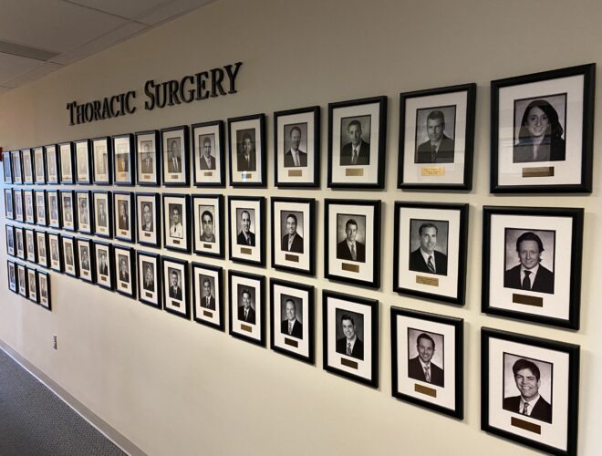 Wall of pictures of Thoracic Surgery Graduates 