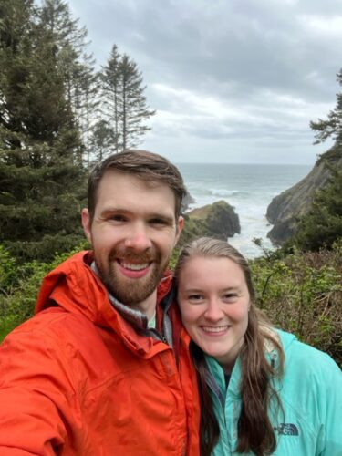 University of Virginia Thomas Quisenberry, MD, Surgery Resident smiles with his wife on a coastal hike.