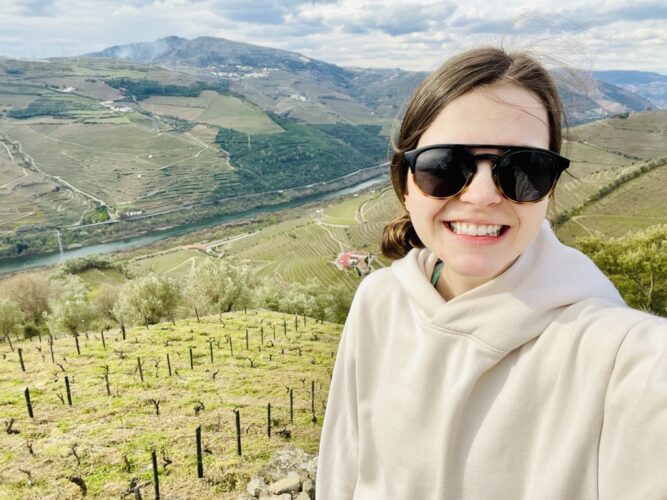 University of Virginia Surgery Resident Gabrielle Steinl, MD smiles outside at a vineyard in the local area.